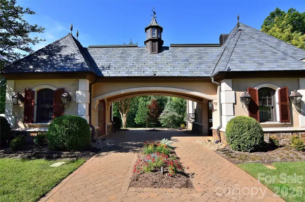 a view of a golf course with a large tree