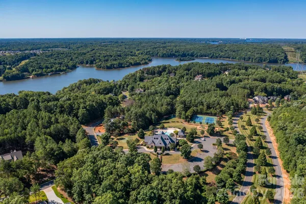 a front view of a house with garden and trees