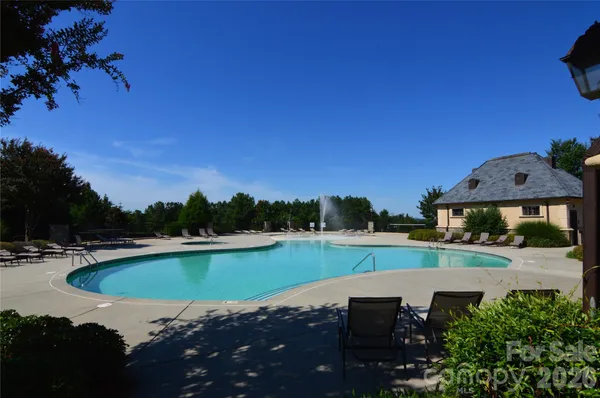 a view of a swimming pool with a yard