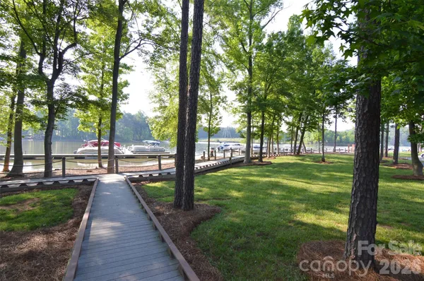 a view of a lake with boats and trees in the background