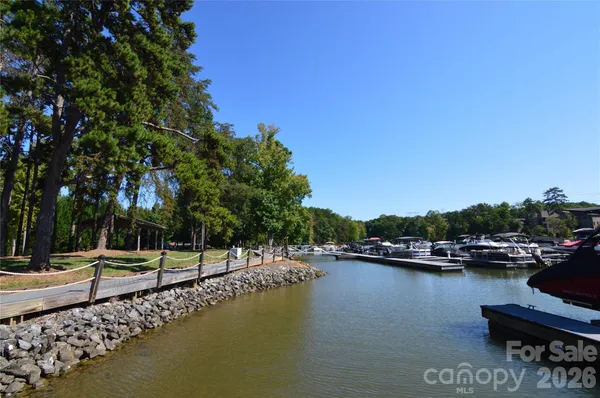 a view of a lake with boats and trees in the background