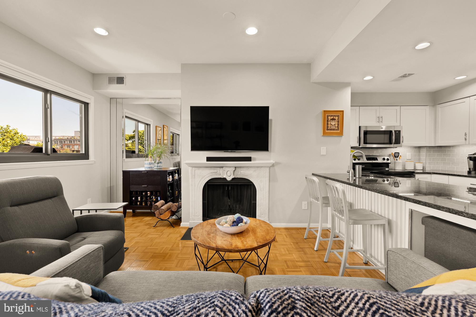 a living room with furniture flat screen tv and a fireplace