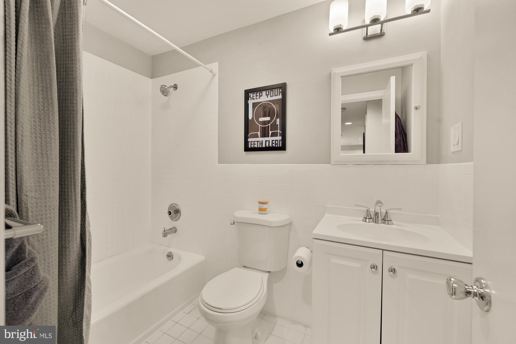 1715 15th Street Northwest, Unit 401 Washington, DC 20009 - Photo 12 of 28 a bathroom with a toilet sink vanity tub and shower