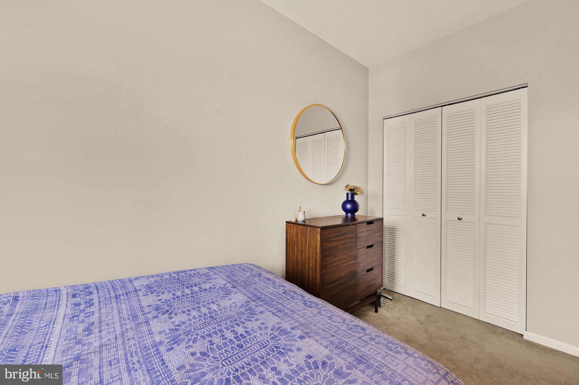 1715 15th Street Northwest, Unit 401 Washington, DC 20009 - Photo 14 of 28 a bed room with a bed and a mirror