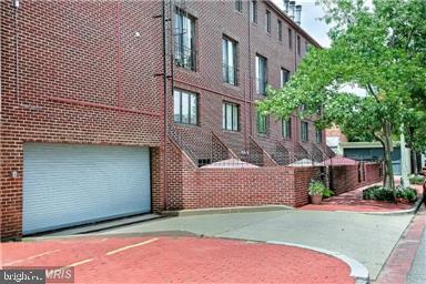 1715 15th Street Northwest, Unit 401 Washington, DC 20009 - Photo 17 of 28 a front view of a house with a yard and garage
