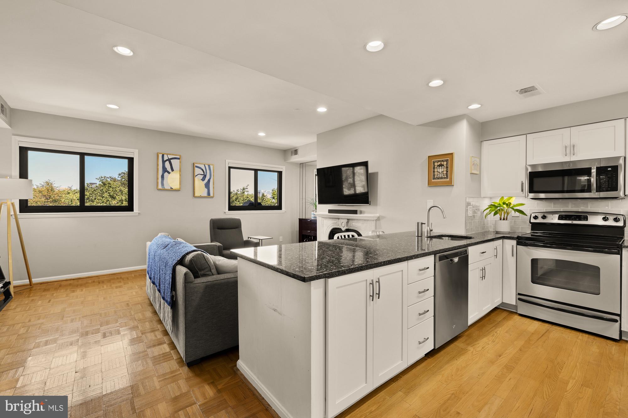 1715 15th Street Northwest, Unit 401 Washington, DC 20009 - Photo 28 of 28 a kitchen with stainless steel appliances granite countertop a sink and cabinets
