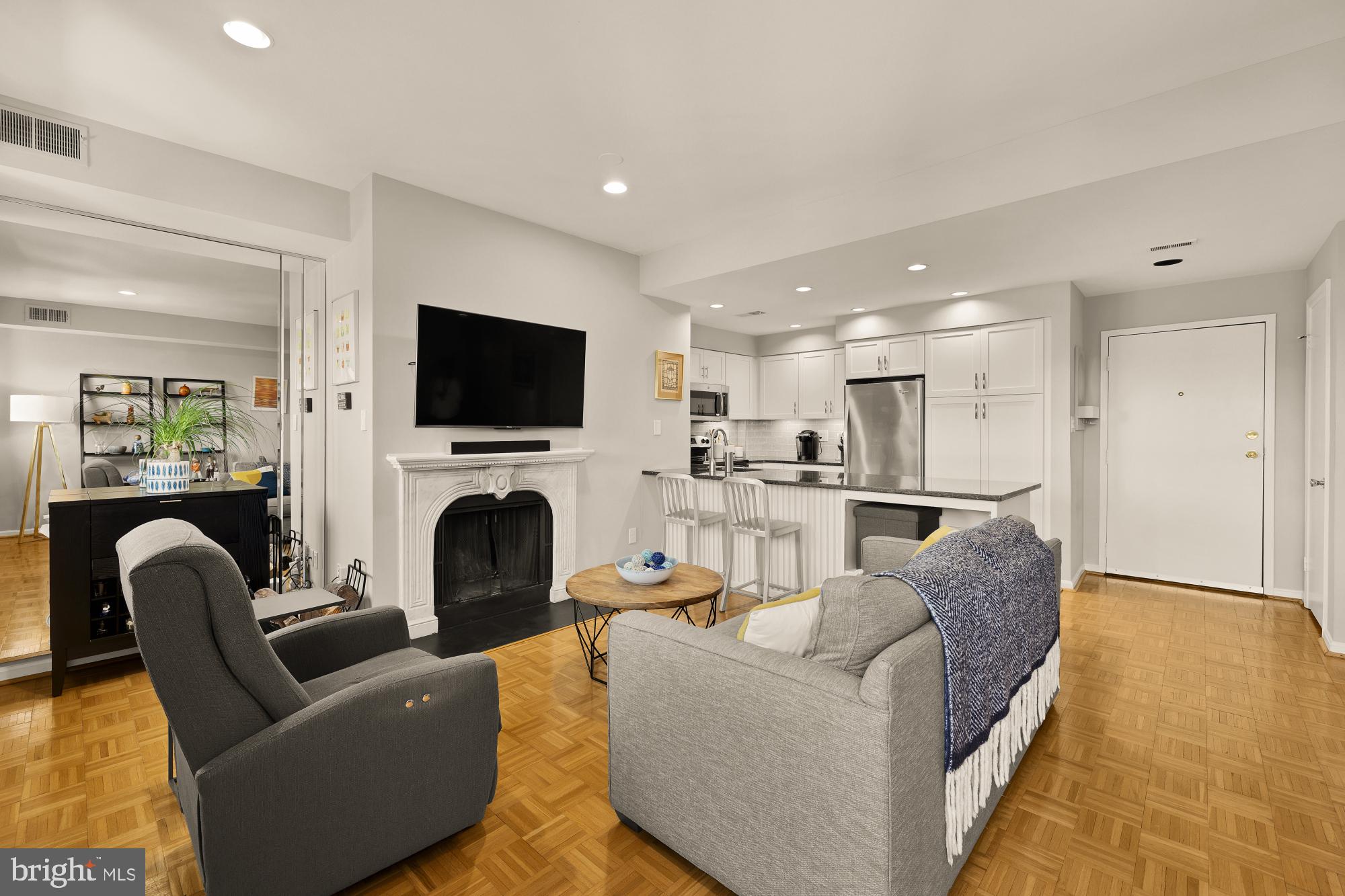 1715 15th Street Northwest, Unit 401 Washington, DC 20009 - Photo 6 of 28 a living room with furniture a fireplace and a flat screen tv