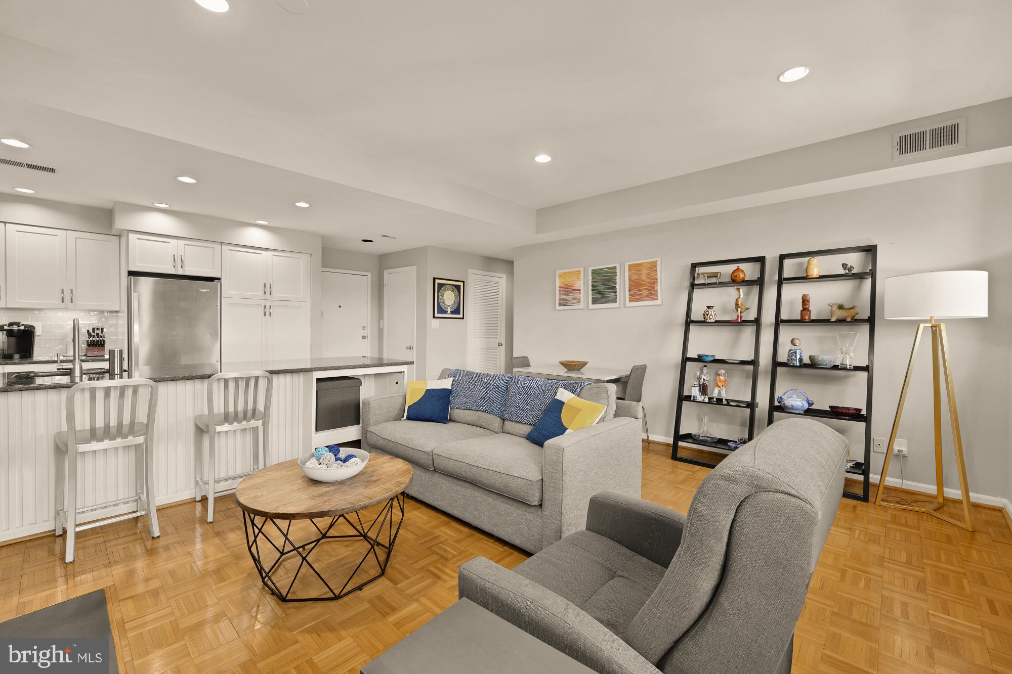 1715 15th Street Northwest, Unit 401 Washington, DC 20009 - Photo 7 of 28 a living room with furniture and a wooden floor