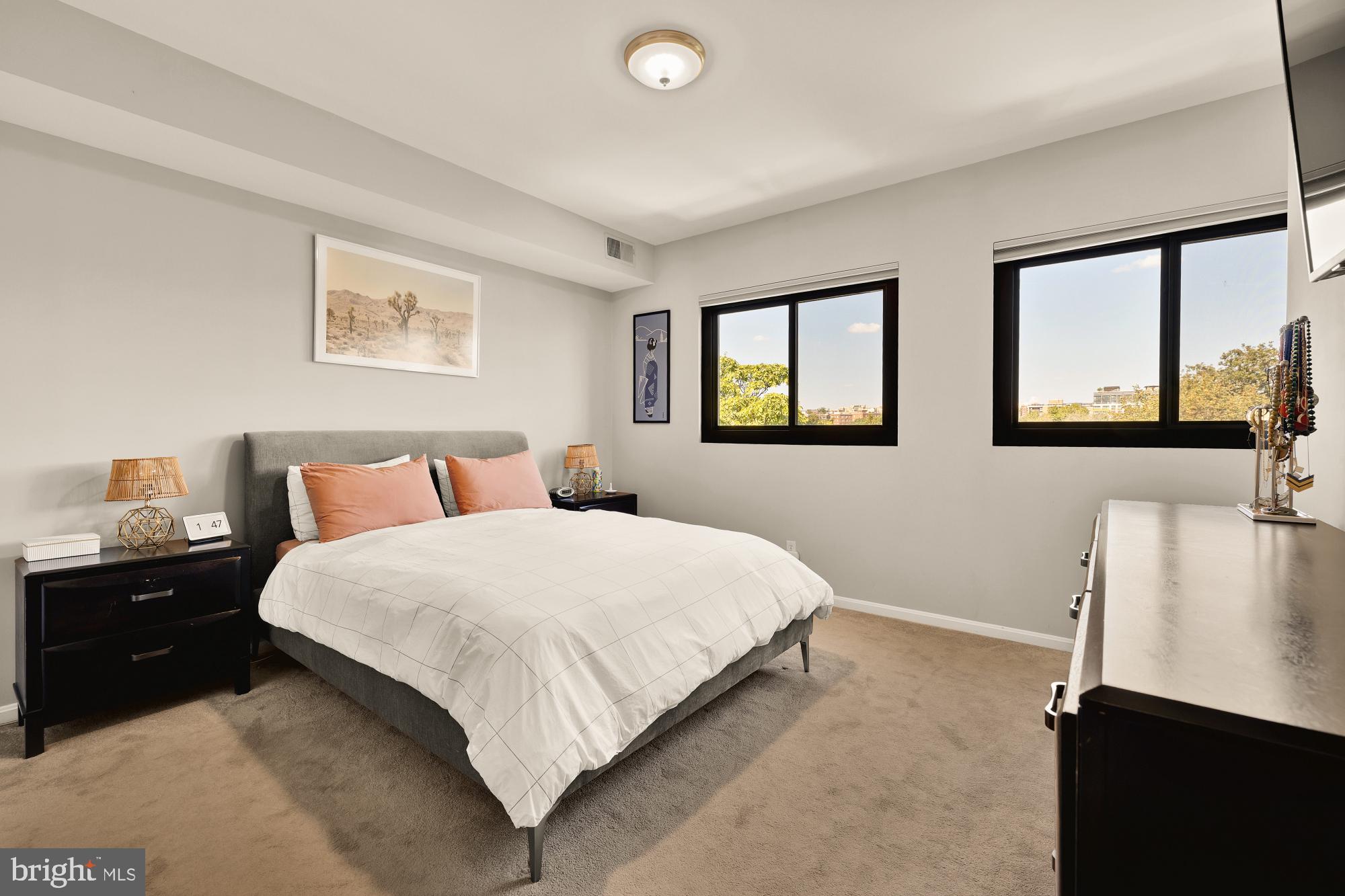 1715 15th Street Northwest, Unit 401 Washington, DC 20009 - Photo 9 of 28 a bedroom with a bed and a night stand