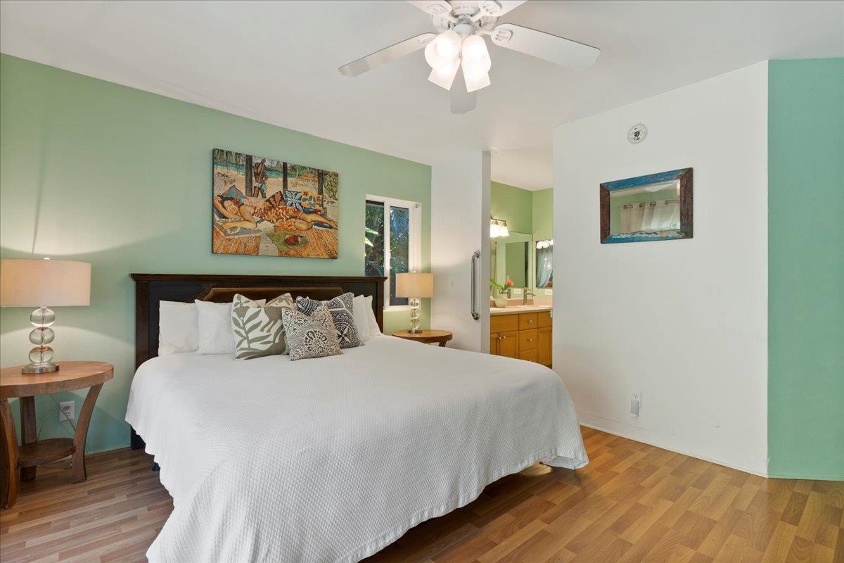 81 Lae Street Paia, HI 96779 - Photo 30 of 47 a bedroom with a large bed and a chandelier