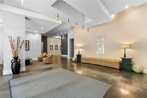 a living room with furniture and a lamp