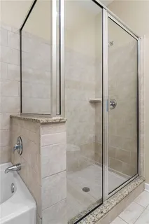 a bathroom with a bathtub and a shower