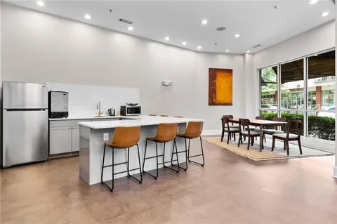 a kitchen with stainless steel appliances kitchen island granite countertop a sink and cabinets