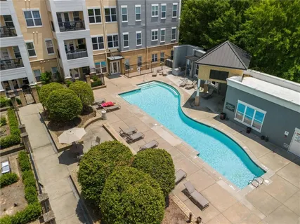 an aerial view of a house with swimming pool and patio
