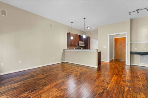 a view of a kitchen with wooden floor and a sink