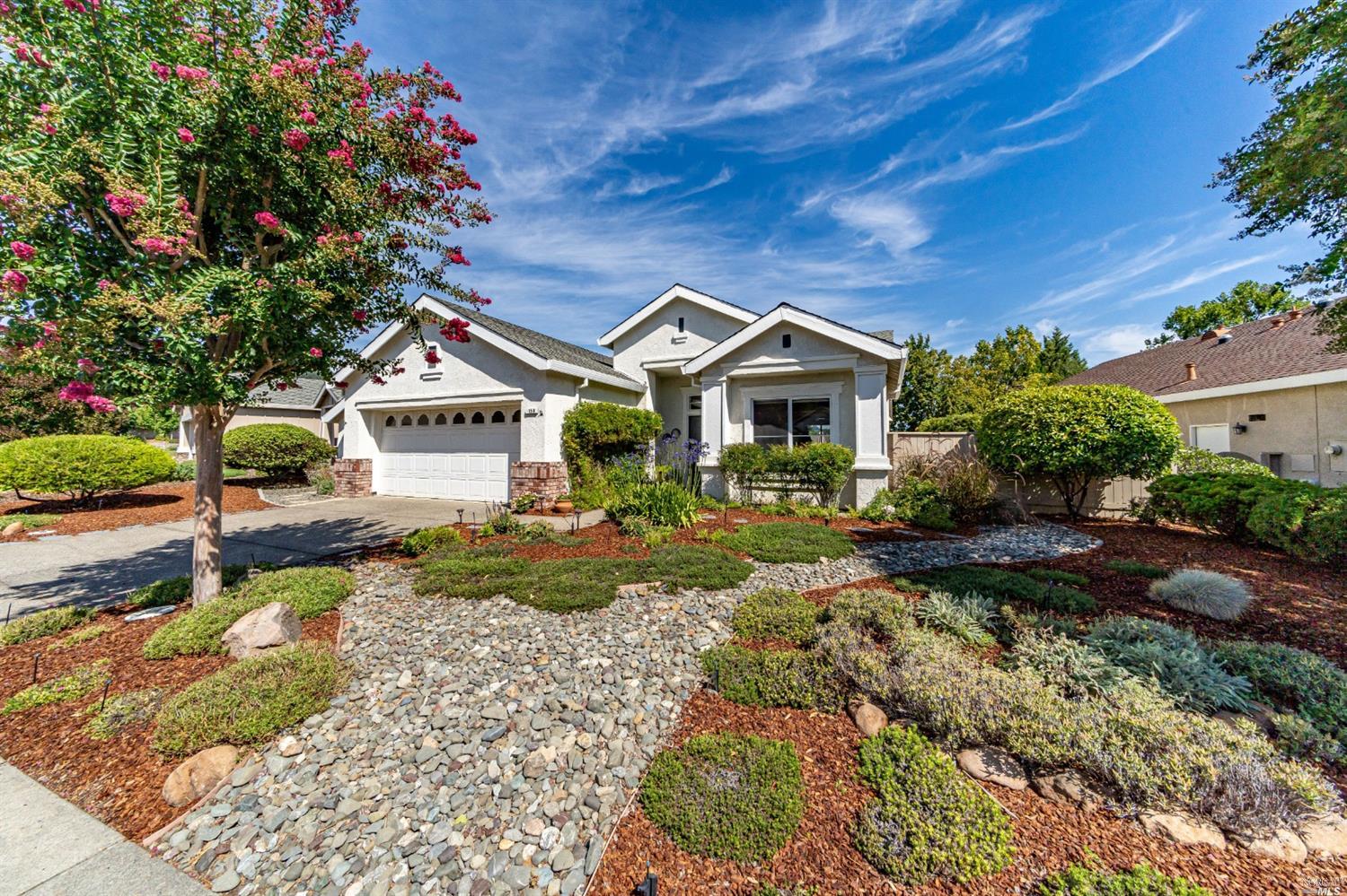 a front view of a house with a garden