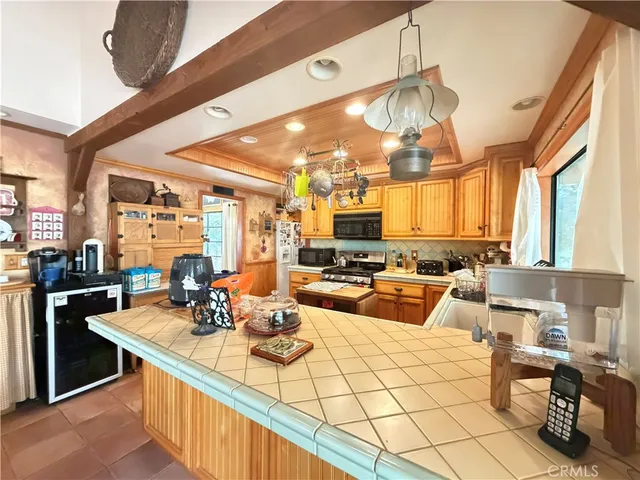 a kitchen with stainless steel appliances kitchen island granite countertop a sink and cabinets