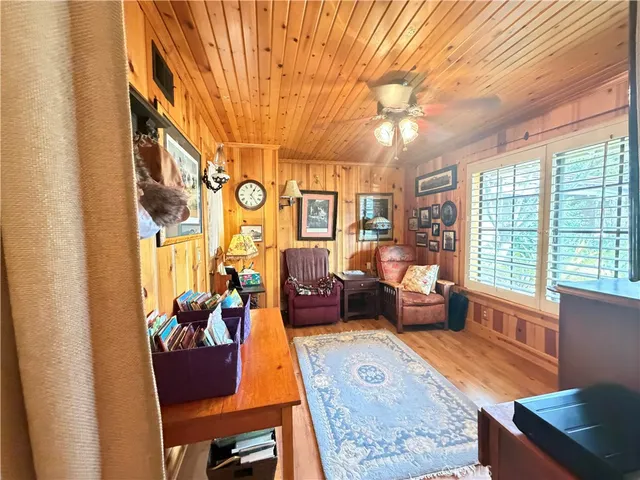 a living room with fireplace furniture and a large window