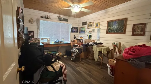 a bedroom with bed a ceiling fan and a couch