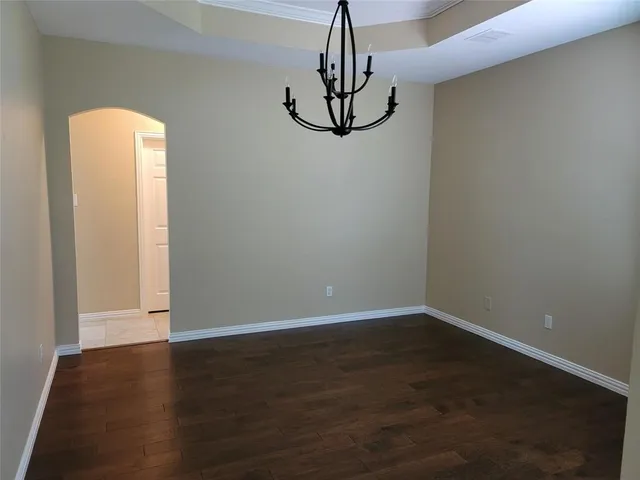 a view of a room with wooden floor and fan