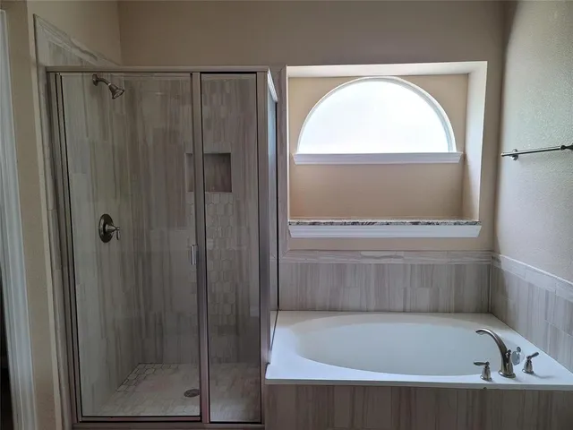 a view of bathroom with bathtub and shower