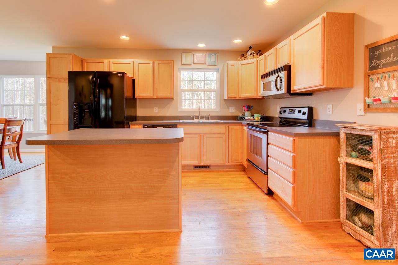1319 Troy Road Troy, VA 22974 - Photo 16 of 41 a large kitchen with stainless steel appliances granite countertop a stove a sink and a refrigerator
