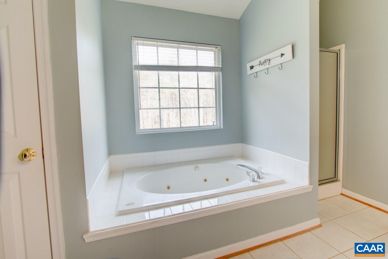 1319 Troy Road Troy, VA 22974 - Photo 29 of 41 a white bath tub sitting next to a window
