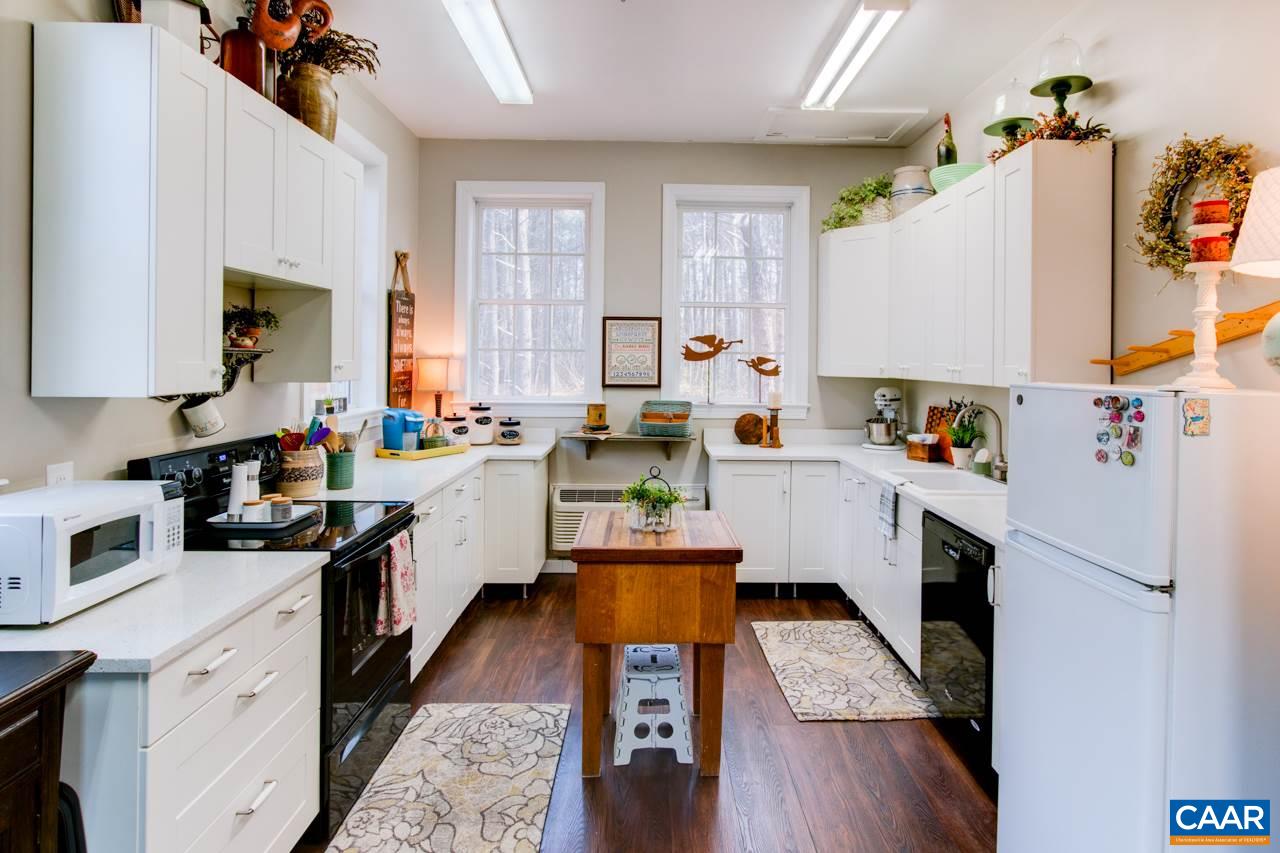 1319 Troy Road Troy, VA 22974 - Photo 32 of 41 a kitchen with stainless steel appliances a stove a sink cabinets and a wooden floor
