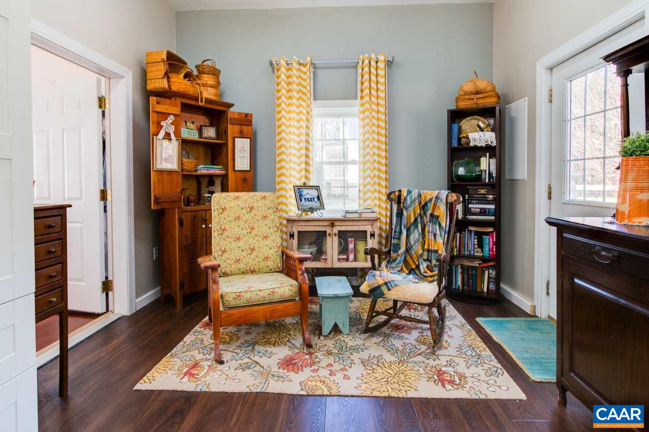 1319 Troy Road Troy, VA 22974 - Photo 35 of 41 a living room with furniture fireplace and wooden floor