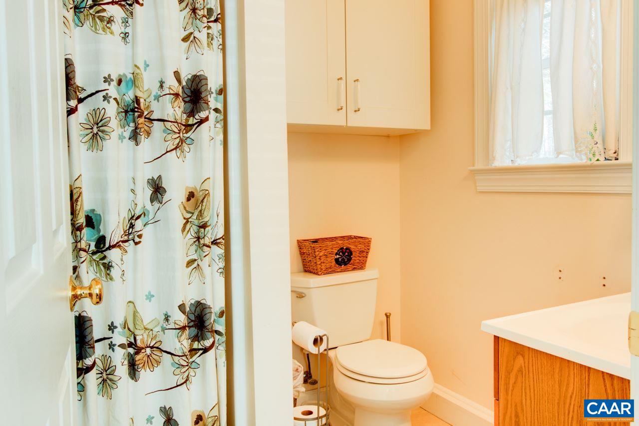 1319 Troy Road Troy, VA 22974 - Photo 37 of 41 a bathroom with a toilet and a shower curtain