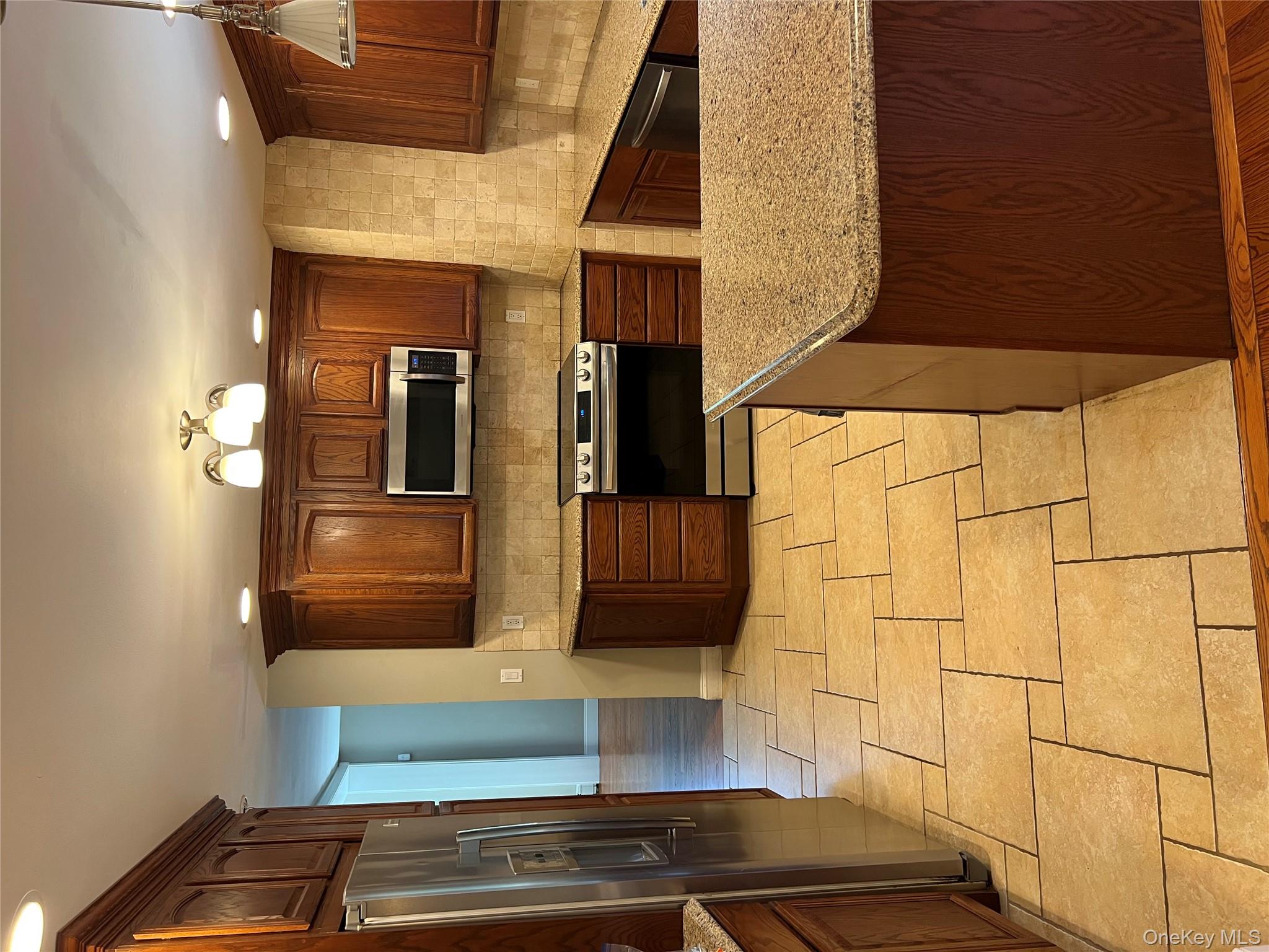 10 Jonah Road Miller Place, NY 11764 - Photo 2 of 16 a kitchen with stainless steel appliances granite countertop a stove granite counter tops and white cabinets