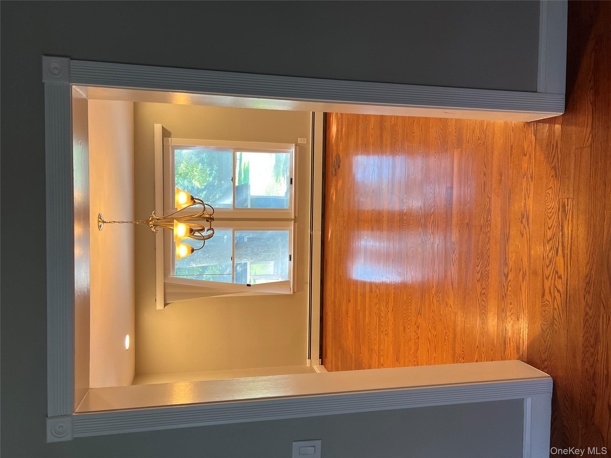 10 Jonah Road Miller Place, NY 11764 - Photo 4 of 16 a view of a room with wooden floor and a window