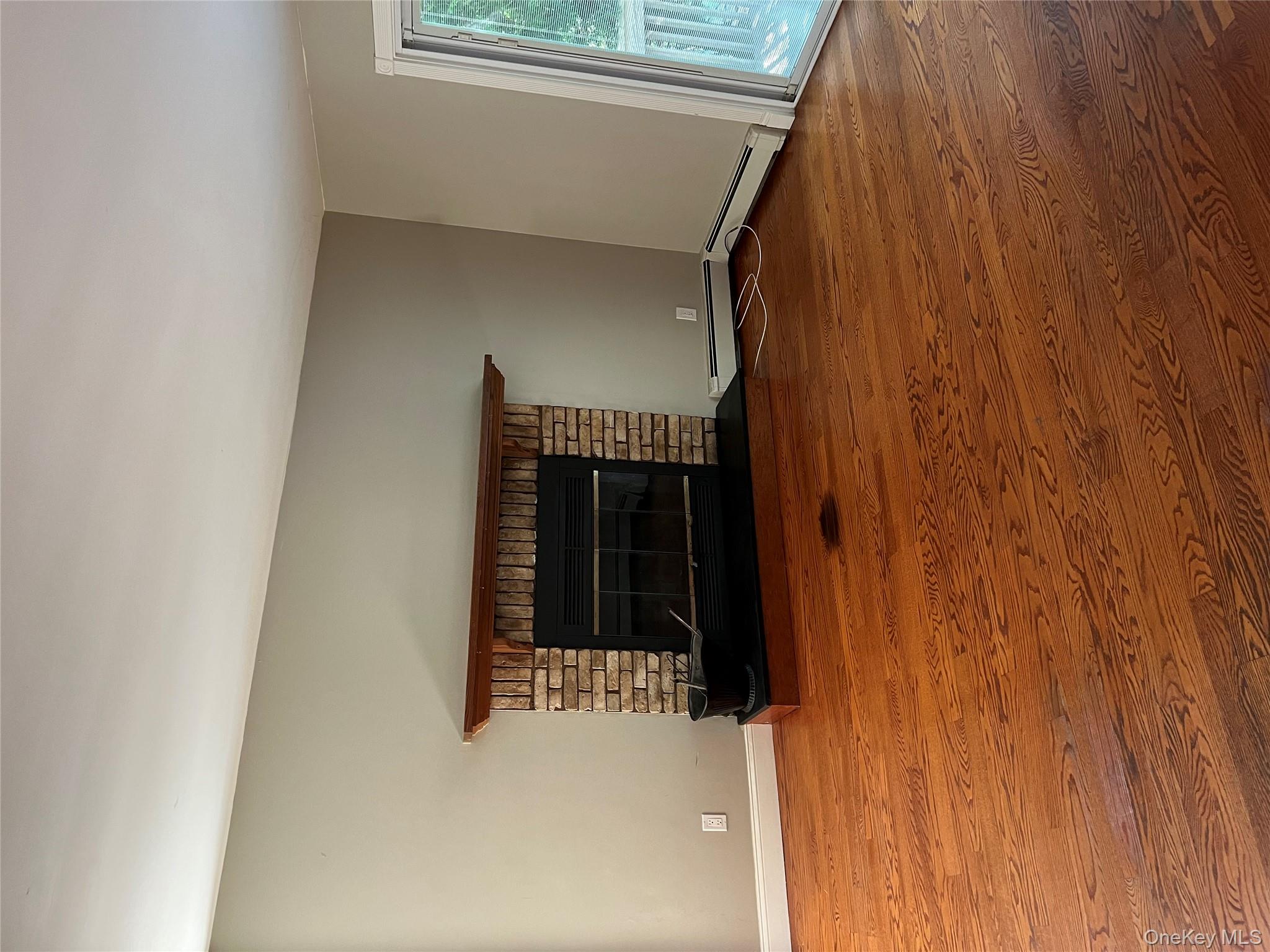 10 Jonah Road Miller Place, NY 11764 - Photo 7 of 16 an empty room with a fireplace