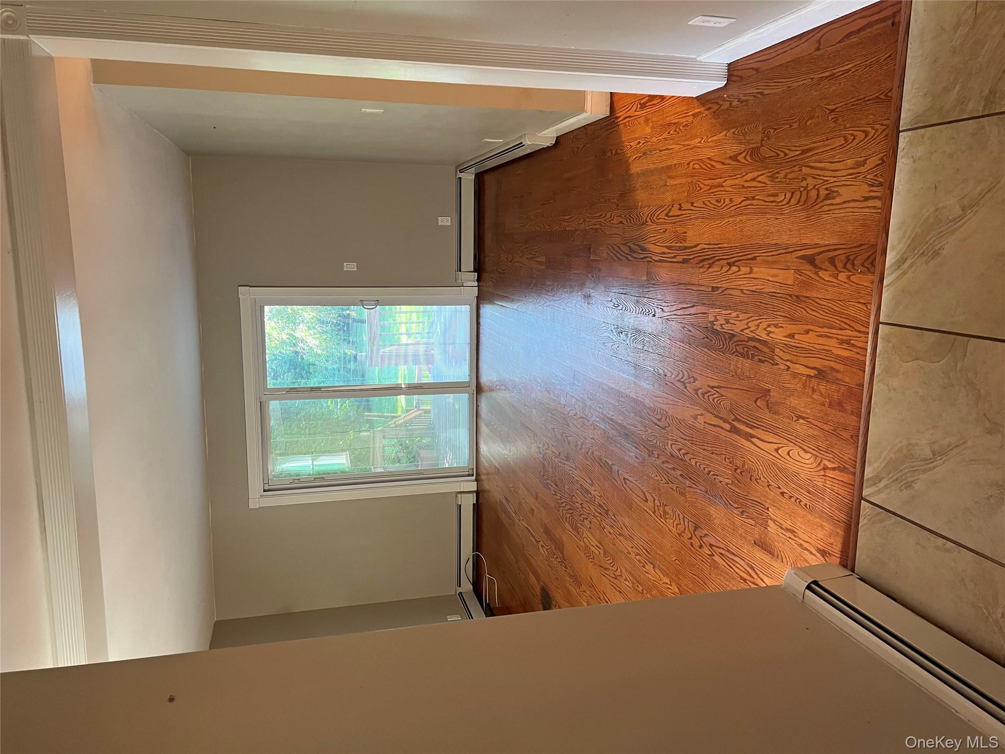 10 Jonah Road Miller Place, NY 11764 - Photo 8 of 16 an empty room with wooden floor and windows