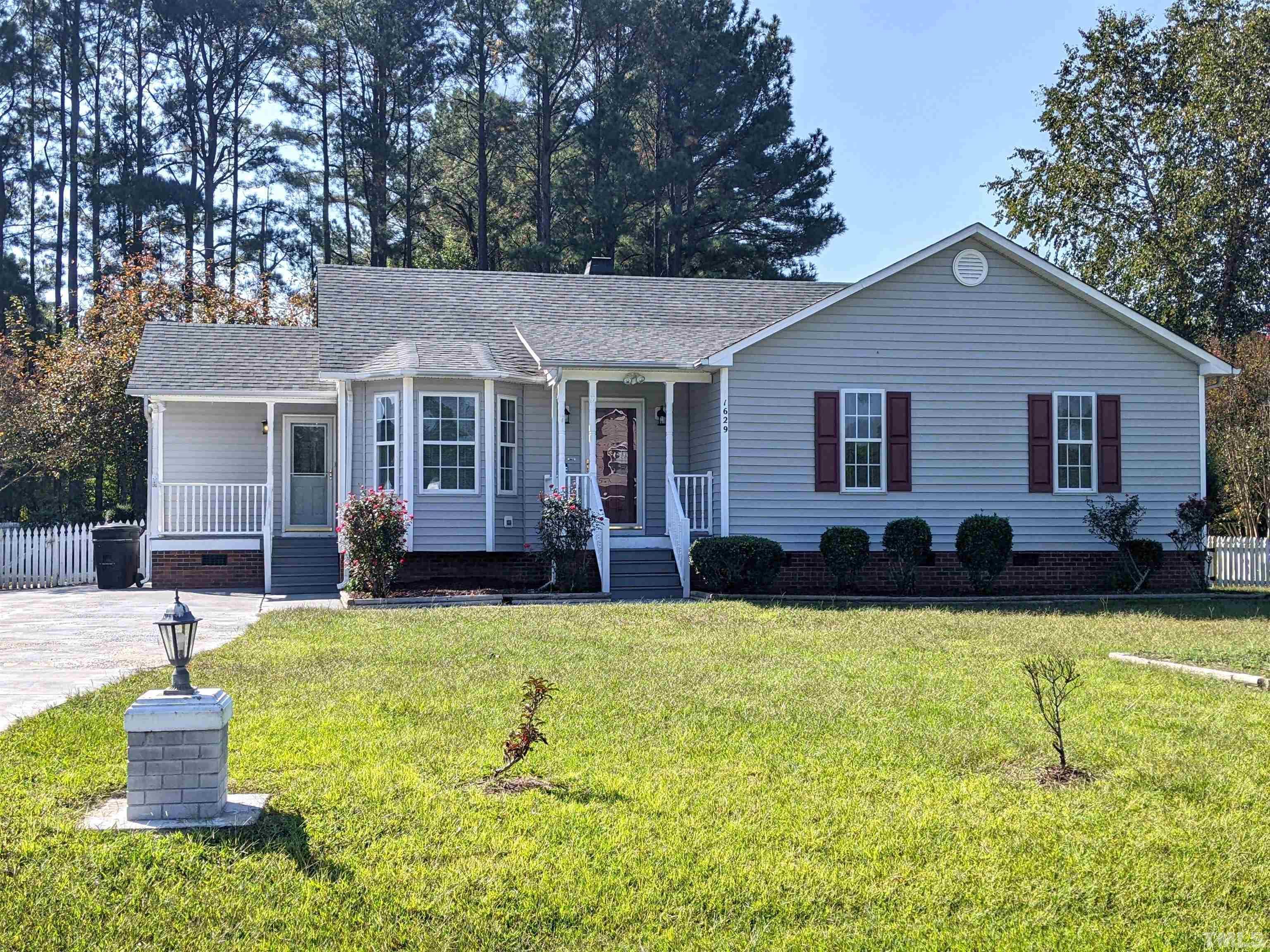 a view of a house with a yard patio and fire pit
