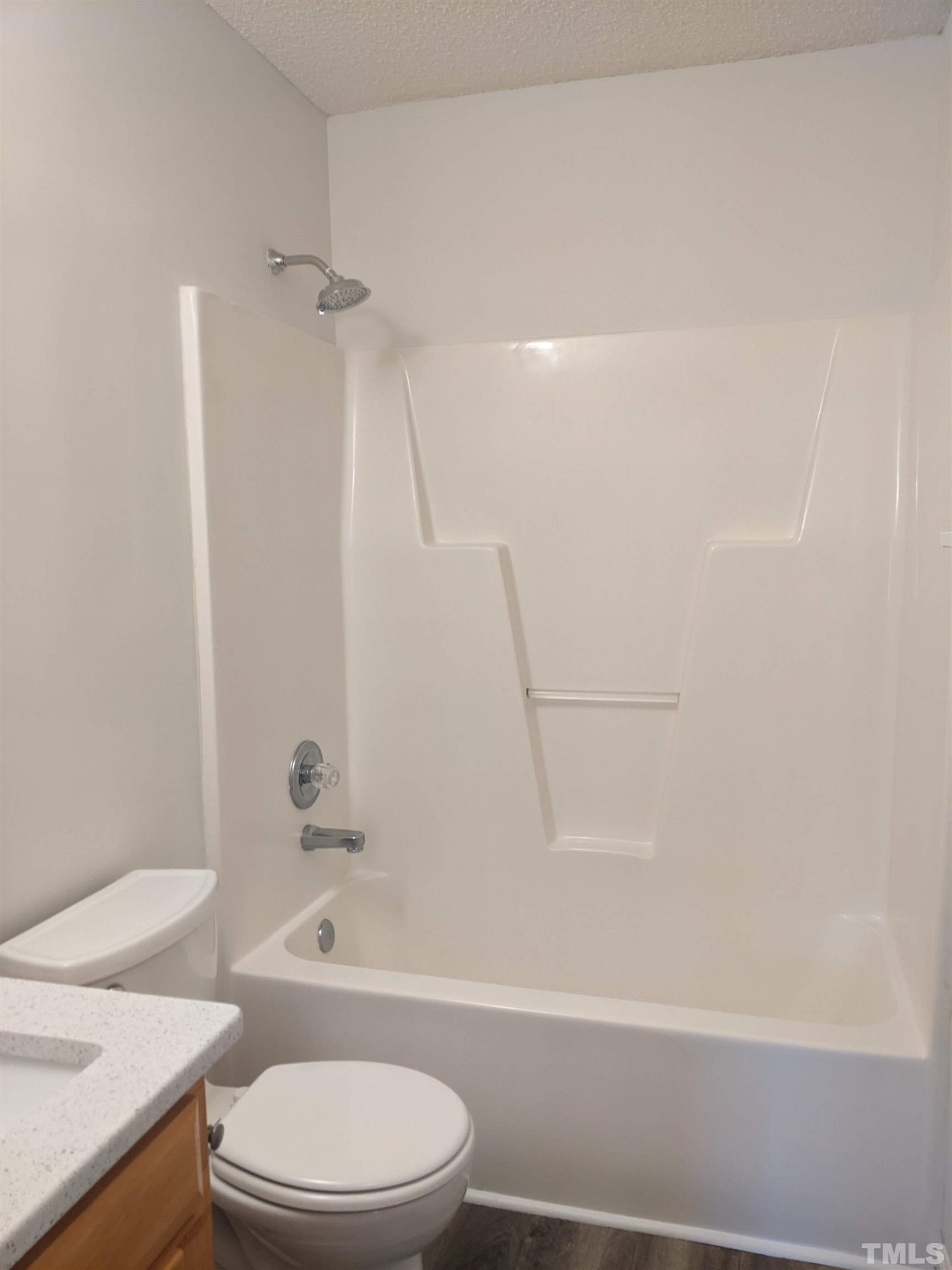 1629 Tall Cane Circle Willow Spring, NC 27592 - Photo 12 of 23 a bathroom with a toilet and a bath tub