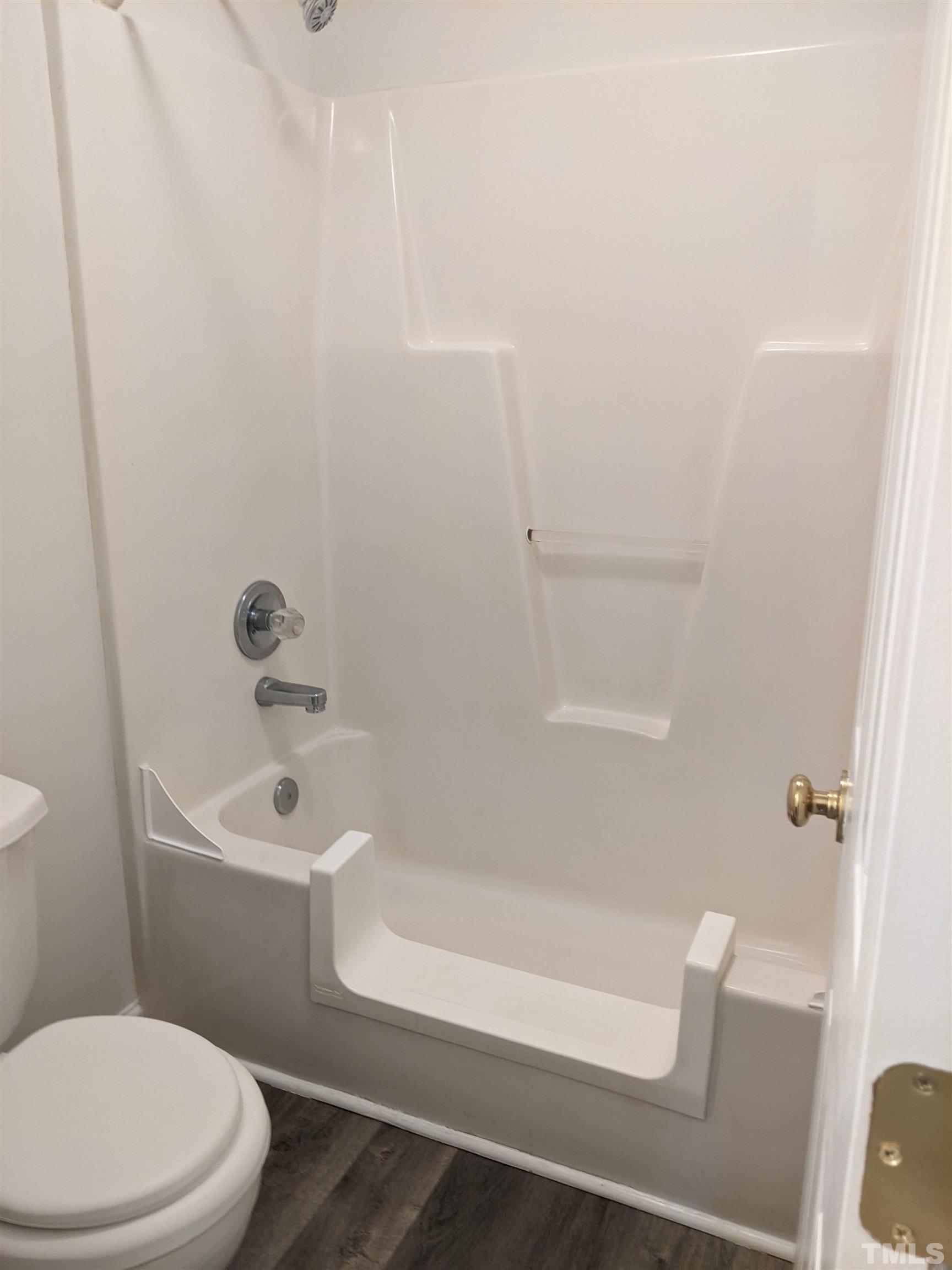 1629 Tall Cane Circle Willow Spring, NC 27592 - Photo 19 of 23 a white toilet and tub sitting next to a bathroom sink