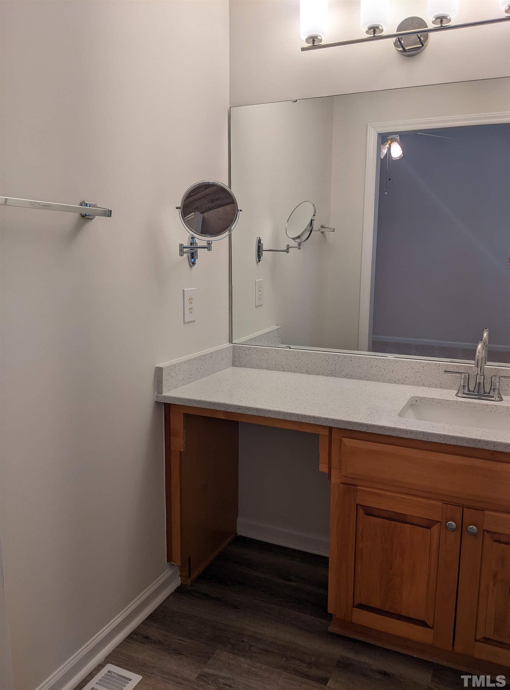 1629 Tall Cane Circle Willow Spring, NC 27592 - Photo 20 of 23 a sink with a mirror