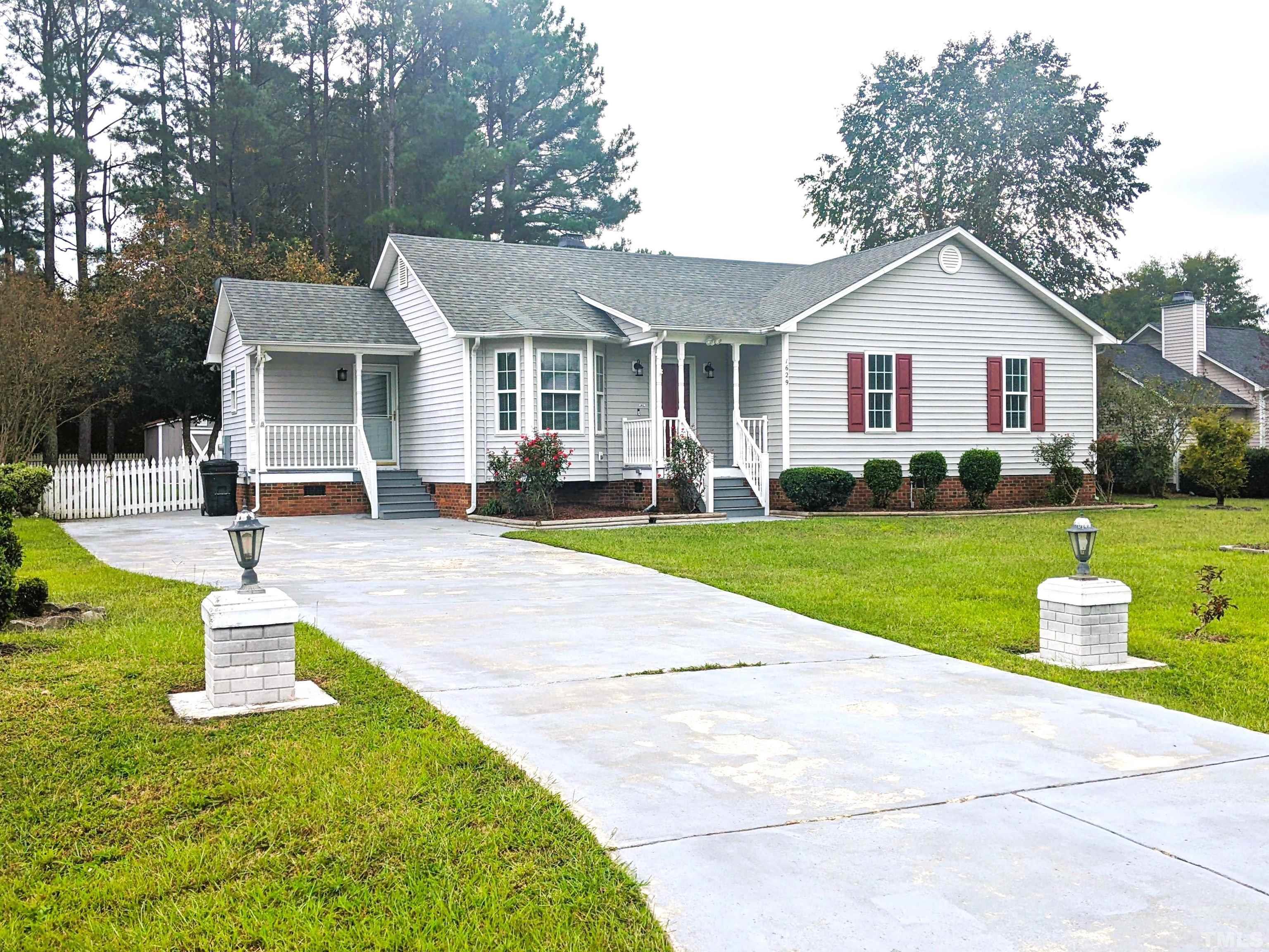 1629 Tall Cane Circle Willow Spring, NC 27592 - Photo 2 of 23 a front view of house with yard and green space