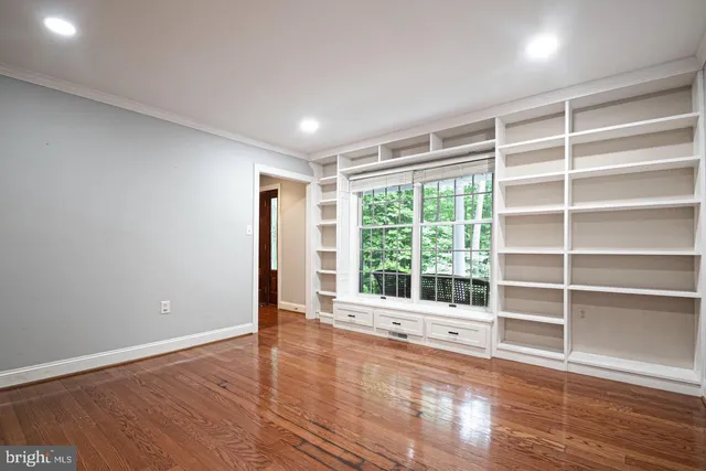 a view of an room with wooden floor fan and a window
