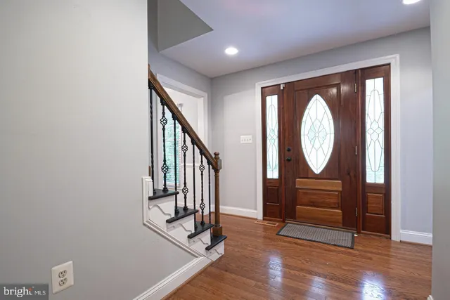 a bedroom with a bed and a chandelier fan