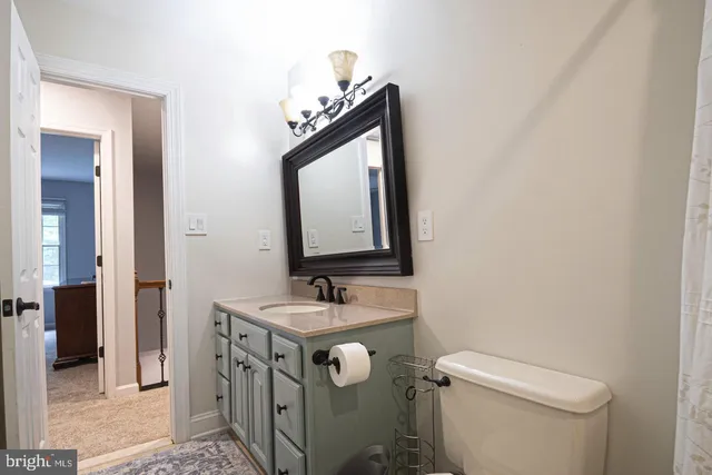 a spacious bedroom with a bed and a chandelier
