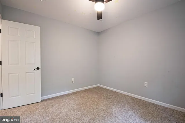 a white toilet sitting next to a shower