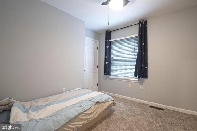 a spacious bathroom with a sink a toilet a shower and a mirror