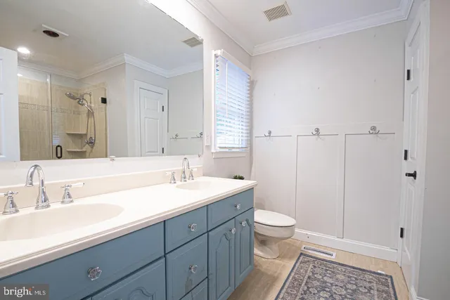 front view of a brick house with potted plants