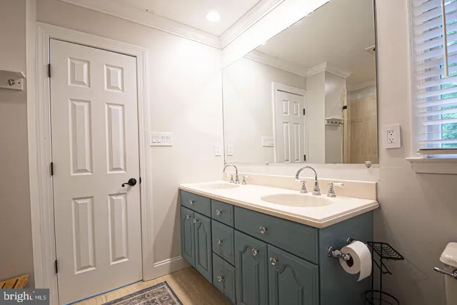a front view of a house with a yard and potted plants