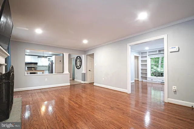 a kitchen with kitchen island granite countertop a table chairs microwave and cabinets