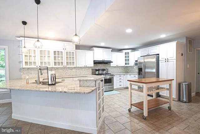 an empty room with wooden floor and natural light