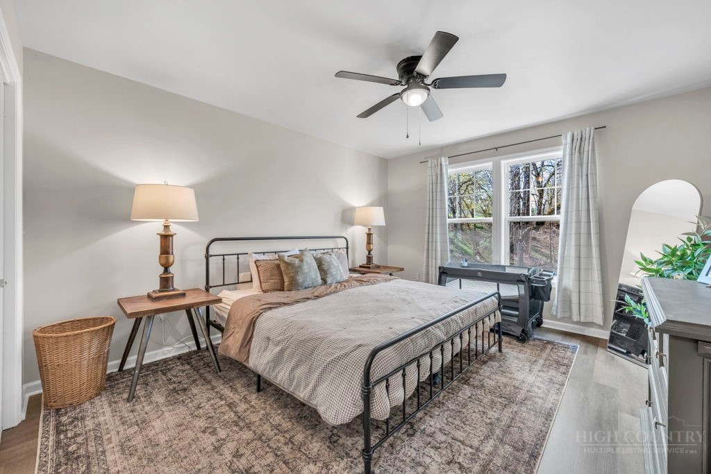 656 Mulatto Mountain Road West Jefferson, NC 28694 - Photo 23 of 35 a large bed sitting in a bedroom next to a window