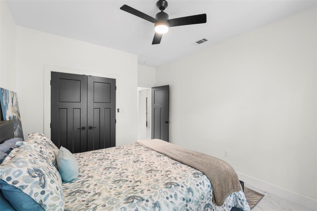 265 Shadow Oaks Streetman, TX 75859 - Photo 17 of 40 a bedroom with a bed and a chandelier